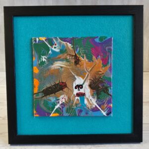 Framed acrylic pour painting, green purple copper and white abstract with red-eyed face, 5x5 canvas on teal felt in black wood-grain frame, front view