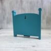 20261020_153146 Crib-shaped nursery shadow box in teal, back view with keyhole wall-hanging slot