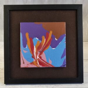 Framed acrylic pour painting, red and orange streaks bursting upward over sky blue, violet and copper, 5x5 canvas on brown felt in black wood-grain frame, front view